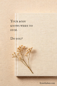 Beige linen journal with a sprig of dried baby's breath resting on the cover beside the words, "Your body knows when to stop. Do you?" reflecting on listening to the body's limits and inner wisdom.